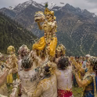 villagers smeared in butter and buttermilk celebrating in a Himalayan meadow