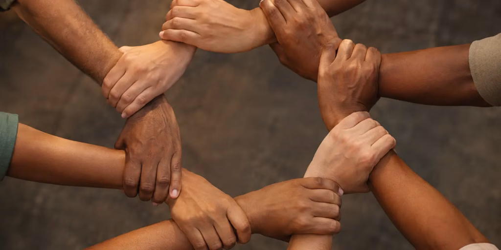 Hands joined together in a circle symbolising unity and harmony