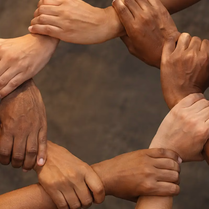 Hands joined together in a circle symbolising unity and harmony