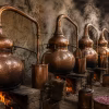 Rows of copper attar stills lined up in a small Kannauj workshop, steam rising off the flames