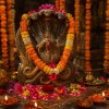 Nag Panchami worship with a Naga idol, flowers and traditional offerings
