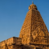 The towering vimana of the Brihadeeswara Temple against a clear sky.