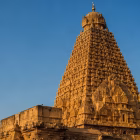 The towering vimana of the Brihadeeswara Temple against a clear sky.
