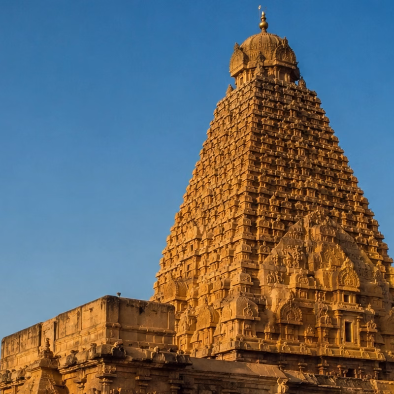 The towering vimana of the Brihadeeswara Temple against a clear sky.