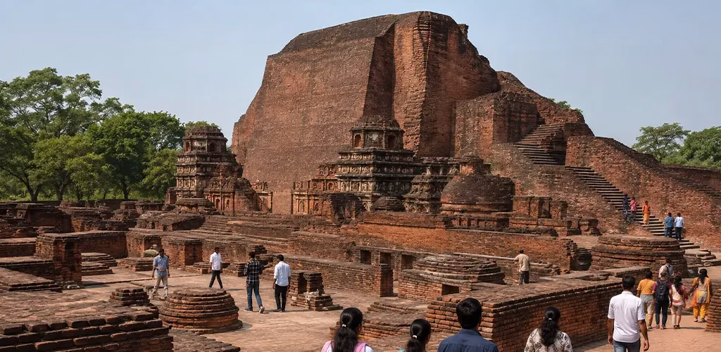 Present-day visitors walking through the excavated ruins of Nalanda University