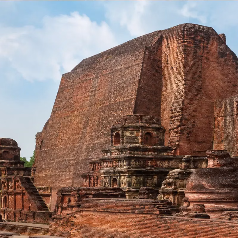 The red brick ruins of Nalanda University standing under an open sky in Bihar