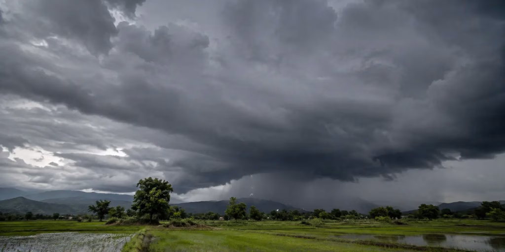 Storm clouds gathering over Indian farmland during monsoon season