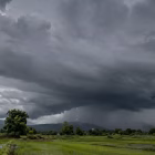 Storm clouds gathering over Indian farmland during monsoon season