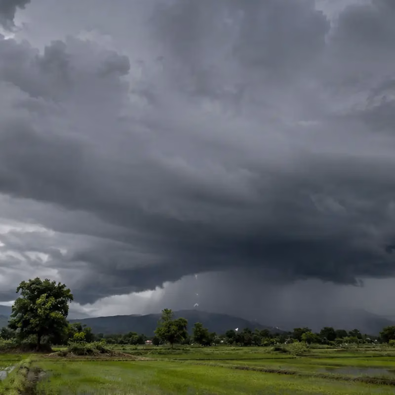 Storm clouds gathering over Indian farmland during monsoon season